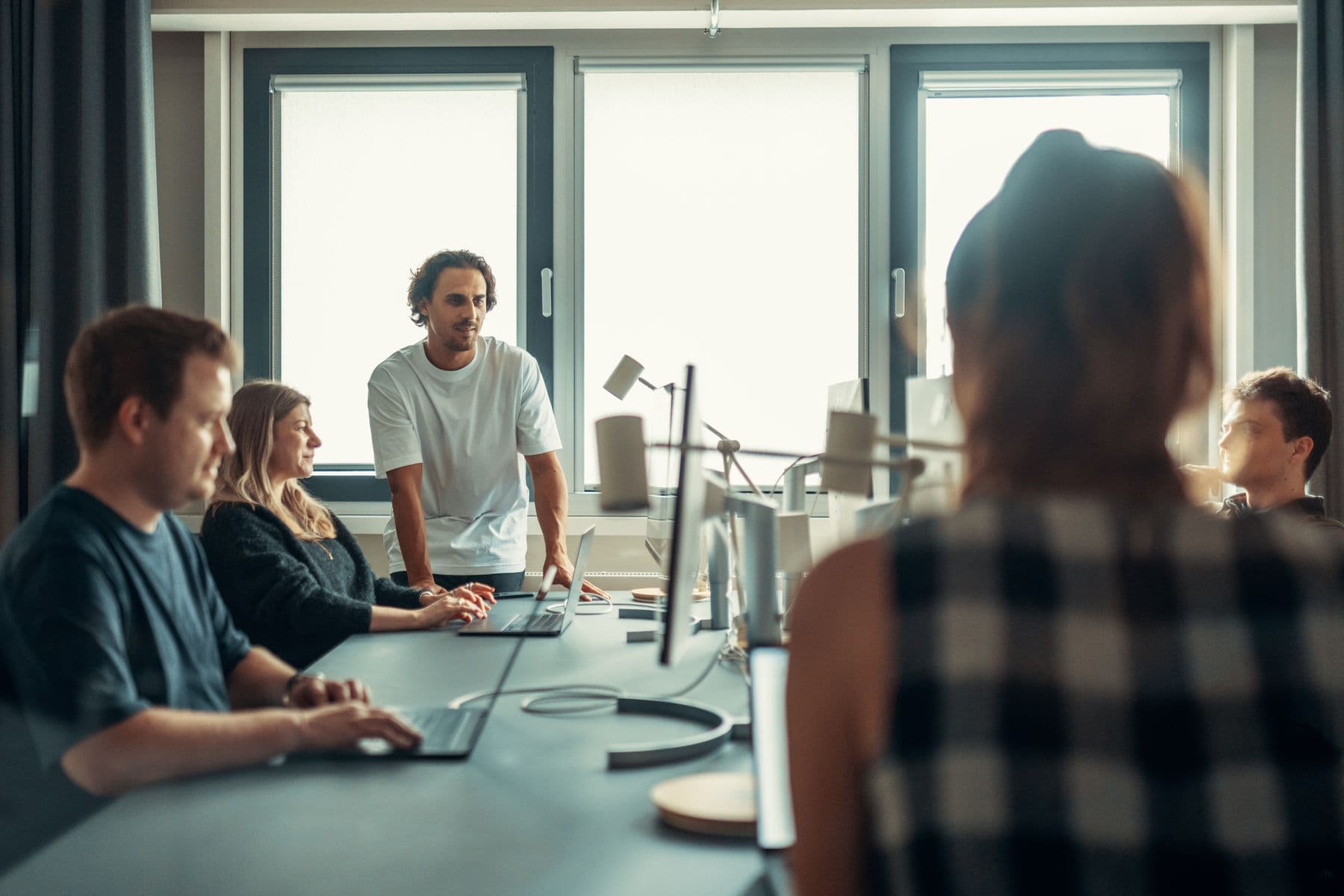Designers and engineers collaborating around a desk